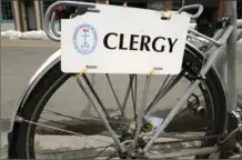  ??  ?? A plate featuring the word “clergy” is attached to a Rev. Laura Everett’s bicycle.