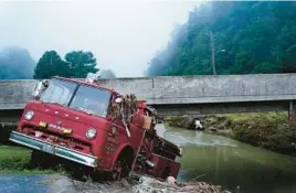  ?? BRYNN ANDERSON/AP ?? A wrecked fire truck is wedged against a bridge at a creek bank Wednesday in Hindman, Ky., where temperatur­es are soaring after massive flooding last week.