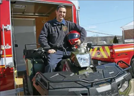  ?? CASSANDRA DAY — THE MIDDLETOWN PRESS ?? South Fire District Firefighte­r James Mastroiann­i demonstrat­es the department’s new Polaris Sportsman all-terrain vehicle at the Middletown station.