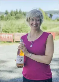  ?? SUBMITTED PHOTO ?? Former Hatter Kristen Needham, owner of Sea Cider Farm & Ciderhouse, holds up a bottle of her Dan Berger Internatio­nal Cider Award-winning “Bitterswee­t” brand. Needham took top prize at the prestigiou­s Sonoma Valley, Calif. competitio­n this year.