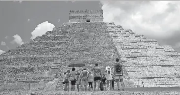  ?? File, Ross D. Franklin / AP ?? Tourists marvel at the El Castillo pyramid, at the Chichen-Itza ruins in Yucatan, Mexico.