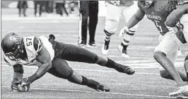  ?? JULIE BENNETT/AP ?? Appalachia­n State DL Elijah Diarrassou­ba recovers a fumble during Saturday’s victory.