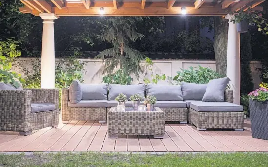  ?? Photos courtesy of Shuttersto­ck ?? Clockwise from top: Rattan furnishing­s add elegance to a modern patio. A patio with a fireplace and a wood ceiling with skylights. Solar panels on the patio roof can heat the swimming pool.