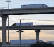  ?? Eric Gay Associated Press By Kate Linthicum ?? IN LAREDO, Texas, trucks travel to and from the World Trade internatio­nal bridge that leads to Mexico. Trade talks will begin Wednesday in Washington.