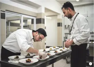  ??  ?? A. Near the end of his nine- day visit to Zanzibar, Frisch cooked for a dinner showcasing local ingredient­s. His dish was grilled octopus over squid-ink rice cooked with cinnamon and nutmeg leaves, topped with pickled nutmeg fruit and cardamom-fried...