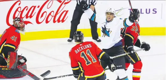  ?? PHOTOS: AL CHAREST ?? San Jose Sharks winger Evander Kane celebrates after scoring one of his four goals in a 7-4 victory over the host Flames on Friday night at the Saddledome.