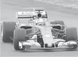  ?? ASSOCIATED PRESS ?? Sebastian Vettel steers the new Ferrari Formula One SF70H racer at the Ferrari Fiorano private test track in Maranello, Italy.