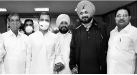  ?? PHOTO: PTI ?? (From left) AICC General Secretary Harish Rawat, Congress MP Rahul Gandhi, Punjab’s new Chief Minister Charanjit Singh Channi, and PPCC President Navjot Singh Sidhu after the oath-taking ceremony at Raj Bhavan in Chandigarh on Monday