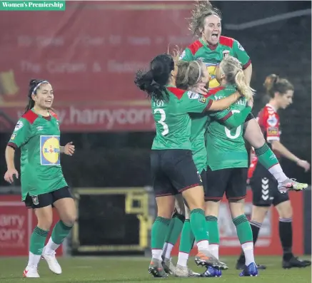  ?? KELVIN BOYES/PRESSEYE ?? Glens glee:
Samantha Kelly is mobbed by her team-mates at Seaview after opening the scoring