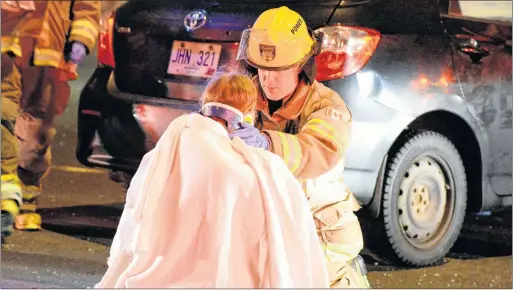  ?? KEITH GOSSE/THE TELEGRAM ?? A St. John’s firefighte­r assists one of three female accident victims after a serious accident Saturday night on Columbus Drive between Thorburn Road and Old Penneywell Road. Police say that alcohol is a factor in the crash. Now the sister of one of...