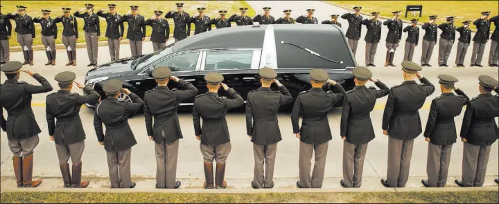  ?? Smiley N. Pool The Dallas Morning News via The Associated Press ?? The hearse bearing the body of former first lady Barbara Bush passes through members of the Texas A&M Corps of Cadets on Saturday in College Station, Texas. After a funeral in Houston, Bush was buried near her husband’s presidenti­al library.