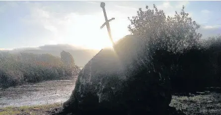  ??  ?? > The ‘sword in the stone’ inspired by King Arthur’s Excalibur at Llangorse Lake before its theft