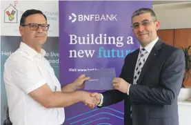  ??  ?? George Debono, Chief Commercial Officer at BNF Bank with Martin Xuereb, Chairperso­n of RMHC Malta