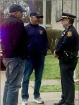 ?? ?? Wayne Withrow, left, and Bill Garrison — both cousins of slain Pittsburgh police Officer Paul J. Sciullo II — talk with Lt. Anthony Cunninham outside the Zone 5 police station in Highland Park on Thursday.