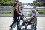  ??  ?? Jose, 45, pushes her son Pol’s stroller as she walks with her family.