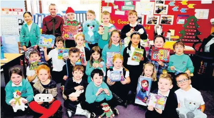  ??  ?? Caring Principal teacher Aaron Kirkwood and some of the many Balfron Primary pupils who responded so enthusiast­ically to the Observer’s Give A Gift Appeal