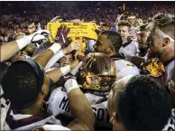  ?? ANDY MANIS — THE ASSOCIATED PRESS FILE ?? Minnesota players celebrate with the Paul Bunyan Axe trophy after beating Wisconsin 37-15in an NCAA college football game, in Madison, Wis., on Nov. 24, 2018.