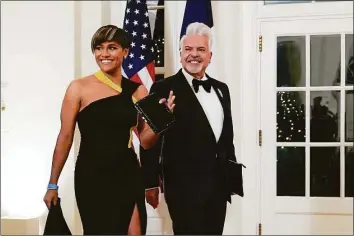  ?? Susan Walsh / Associated Press ?? Actor Ariana DeBose and Henry Munoz III arrive for the State Dinner with President Joe Biden and French President Emmanuel Macron at the White House on Dec. 1.