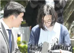  ??  ?? Cho Hyun-ah (right) arrives at an immigratio­n office in Seoul. — AFP photo