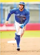  ?? Steve Nesius/The Canadian Press via AP ?? ■ Toronto Blue Jays' George Springer races to third base on an infield ground ball during the first inning of a spring training game against the Philadelph­ia Phillies on Saturday in Dunedin, Fla.