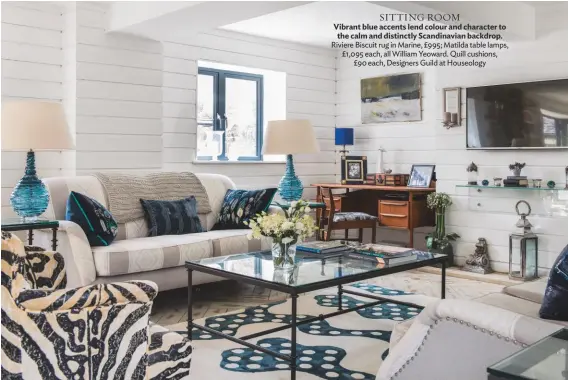  ??  ?? SITTING ROOM Vibrant blue accents lend colour and character to the calm and distinctly Scandinavi­an backdrop. Riviere Biscuit rug in Marine, £995; Matilda table lamps, £1,095 each, all William Yeoward. Quill cushions, £90 each, Designers Guild at Houseology