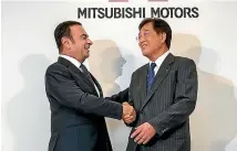  ??  ?? Carlos Ghosn, left, and Mitsubishi Motors chief executive Osamu Masuko when the Japanese company was welcomed into the alliance.