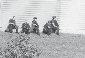  ?? Ron Baselice / Dallas Morning News / Tribune News Service ?? Police look for a suspect in the Tuesday shooting of two police officers and a Home Depot losspreven­tion officer in Dallas. Armando Luis Juarez was arrested after a five-hour manhunt.