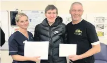  ??  ?? Giving back Aaron Morton handing over the funds to Audrey Mcconnachi­e of University Hospital Wishaw and Andy Mclaren of Chris’s House