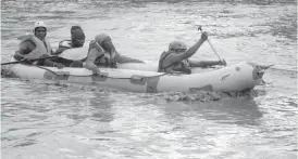  ??  ?? Suspected smugglers on board a dinghy boat as they cross Limpopo River. (Picture by Thupeyo Muleya)