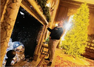  ?? Photos by Santiago Mejia/The Chronicle ?? Kevin Wisney turns on the holiday decoration­s at Filoli Historic House & Garden in Woodside on Nov. 9. The public was allowed to view the holiday preparatio­ns from the inside this year.