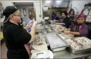  ?? JOHN RAOUX — THE ASSOCIATED PRESS ?? In this Thursday photo, employees clean and prepare various kinds of shrimp at the Dixie Crossroads restaurant in Titusville, Fla. Rock shrimp, once considered trash is celebratin­g 50years as a popular Florida cuisine.