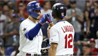  ?? JOHN MINCHILLO — THE ASSOCIATED PRESS ?? American League’s Joey Gallo, left, of the Rangers, is congratula­ted by Francisco Lindor, of the Indians, after Gallo hit a solo home run during the seventh inning of the MLB All-Star Game, Tuesday in Cleveland.