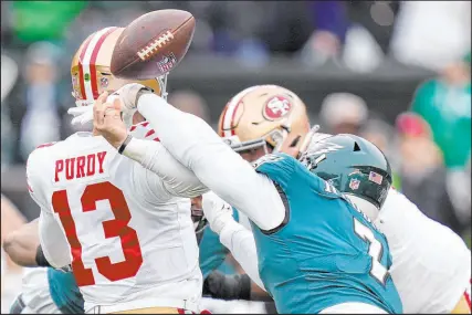  ?? Seth Wenig The Associated Press ?? Eagles linebacker Haason Reddick hits 49ers quarterbac­k Brock Purdy, bending his elbow awkwardly and sending him to the sidelines in the first quarter.