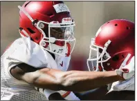  ?? NWA Democrat-Gazette/CHARLIE KAIJO ?? Arkansas freshman Mike Woods (left) has impressed wide receivers coach Justin Stepp. “First off, he’s the hardest-working kid I’ve ever been around in my life,” Stepp said. “He’s a relentless worker, and he’s an incredible young man.”