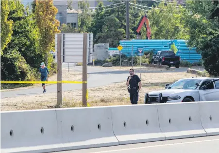  ?? DARREN STONE, TIMES COLONIST ?? The Galloping Goose Regional Trail and Trans-Canada Highway near Harriet Road were blocked Friday morning after an overnight incident that is under police investigat­ion.