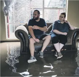  ?? Pictures: Jacques Nelles ?? SATURATED. Brandon Muller and his sister Vanessa on their couch in their flooded home in Centurion yesterday.