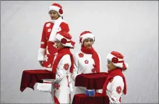  ?? ANDY WONG / AP ?? Chinese attendants rehearse the award ceremony of the men’s 500-meters race during a test event for the
2022 Beijing Winter Olympics at the National Speed Skating Oval in Beijing on Wednesday.