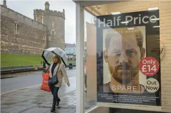  ?? DAN KITWOOD/GETTY ?? Prince Harry’s book “Spare” is advertised this week by a shop opposite Windsor Castle in England.