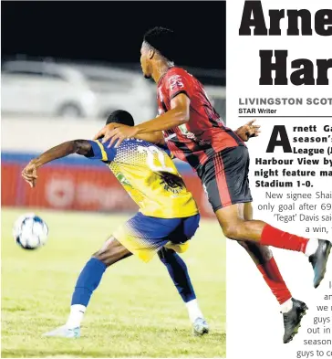  ?? KENYON HEMANS ?? Arnett Gardens’s Earl Simpson (right) rides the back of Calorado Harding of Harbour View while they fight for the ball during their Jamaica Premier League match at the Ashenheim Stadium last night. Arnett won the match 1-0.