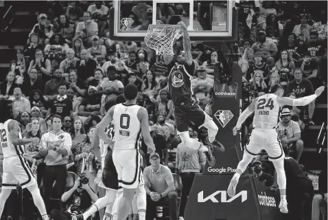  ?? Justin Ford / Getty Images ?? The Warriors’ Gary Payton II soars to the basket Sunday, part of a surprising contributi­on from Golden State’s less-heralded players. Payton will receive plenty of playing time in this series as he will try to make life a bit more difficult for Grizzlies star Ja Morant.