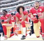  ?? AFP ?? Former San Francisco 49ers quarterbac­k Colin Kaepernick (centre) began kneeling during the US national anthem to protest racial inequality.
