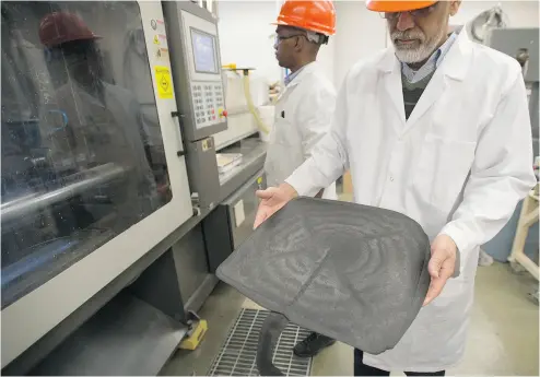  ?? PHOTOS: LAURA PEDERSEN / NATIONAL POST ?? Muhammad Pervaiz holds a seat bottom for a chair that was created from a wood pulp-based compound at the University of Toronto’s Faculty of Forestry. Similar compounds can be used in car parts, dean Mohini Sain says.