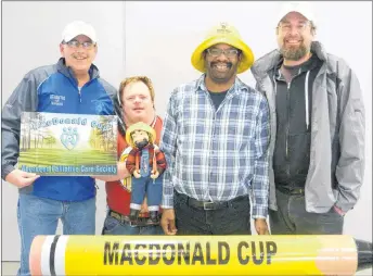  ??  ?? Mike MacNaughto­n, left, and Ian Bos, far right, got some help from Summer Street Industries clients Willie O’Brien and Allister MacLean, in promoting the 18th annual MacDonald Cup Fore Palliative Care golf tournament, which will be held in July.