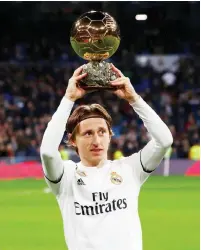  ??  ?? File photo of Real Madrid’s Luka Modric lifting the Ballon d’Or trophy before a La Liga match. — Reuters photo