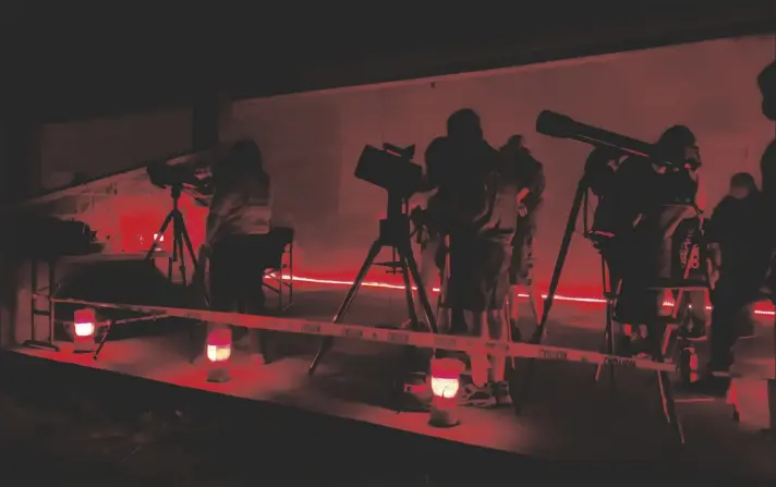  ?? COURTESY PHOTO ?? IVDM staff and visitors gaze into the night sky.