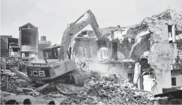  ?? PHOTO: PTI ?? In Prayagraj, the civic body on Sunday demolished ‘illegally constructe­d’ residence of Javed Ahmed, a local leader who was allegedly the key conspirato­r of violent protests against now-suspended BJP leaders