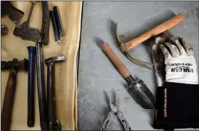  ?? ?? A shovel and a garden mattock that were transforme­d from a firearm sit next to blacksmith­ing tools.