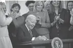  ?? BRENDAN SMIALOWSKI/AFP VIA GETTY IMAGES ?? President Joe Biden signs an executive order on Monday aimed at advancing the study of women’s health.