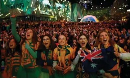  ?? Photograph: Hannah McKay/Reuters ?? Australia fans in the Melbourne fan zone watch the the host nation take on Denmark.