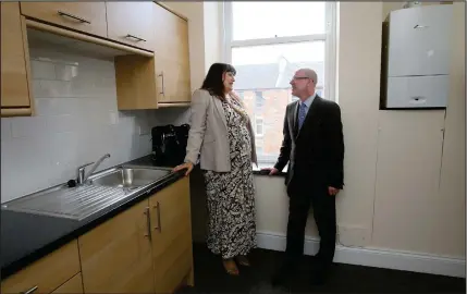  ??  ?? Housing Minister Kevin Stewart, with Annie Macfarlane, of Govanhill Housing Associatio­n, which had planned a rent increase